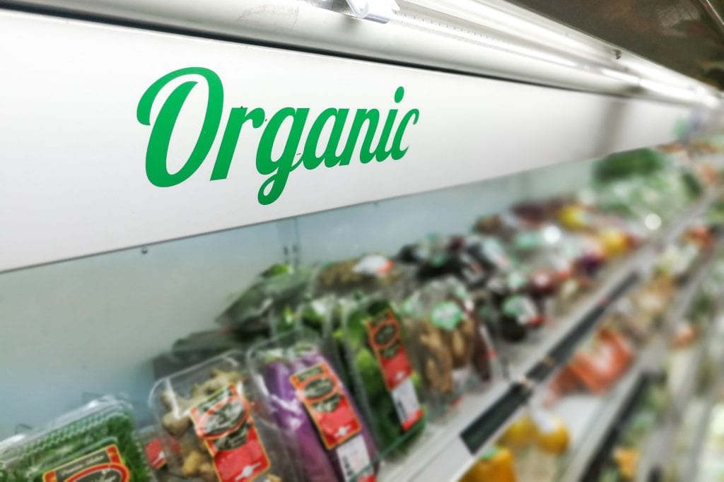 Organic food signage on modern supermarket fresh produce vegetab