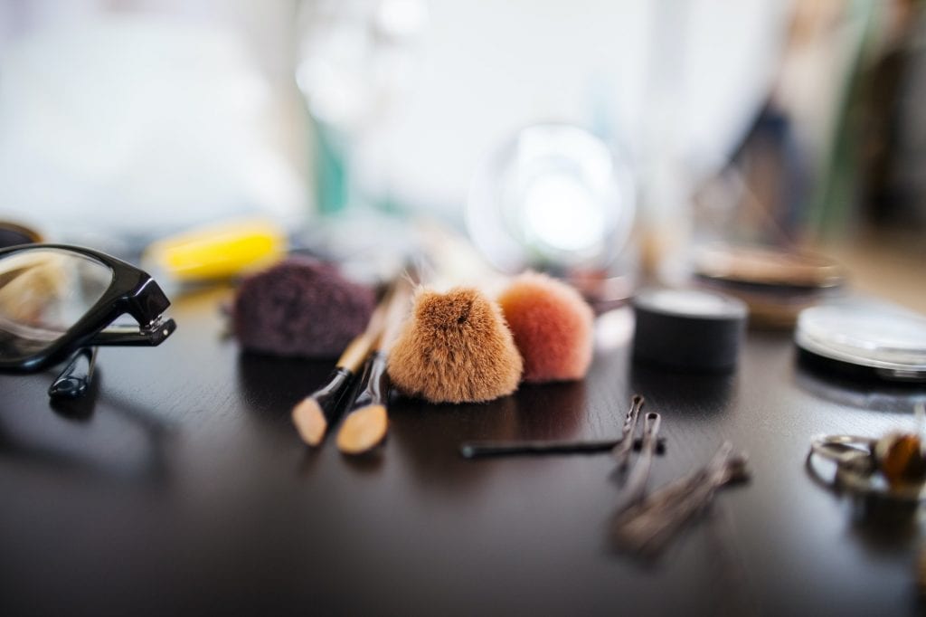 Various beauty products on table in studio