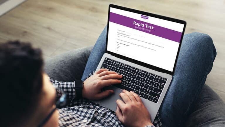 Laptop showing the MPOWER rapid test booking page