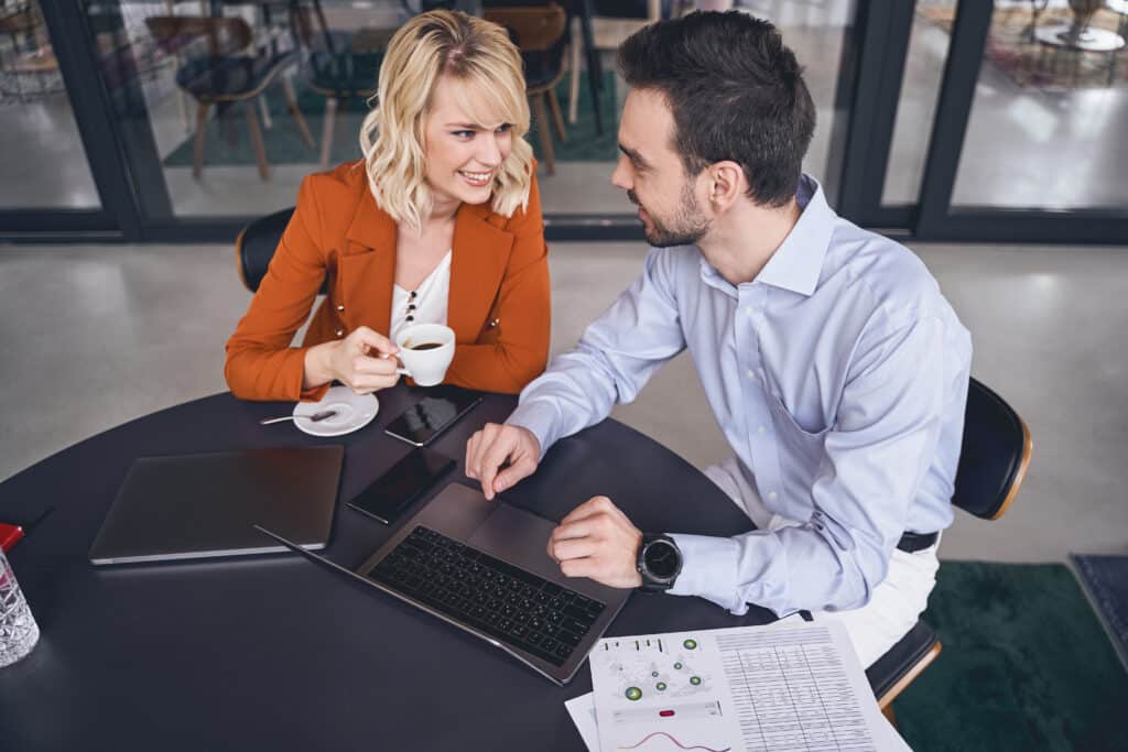Consultant and client talking at a meeting table