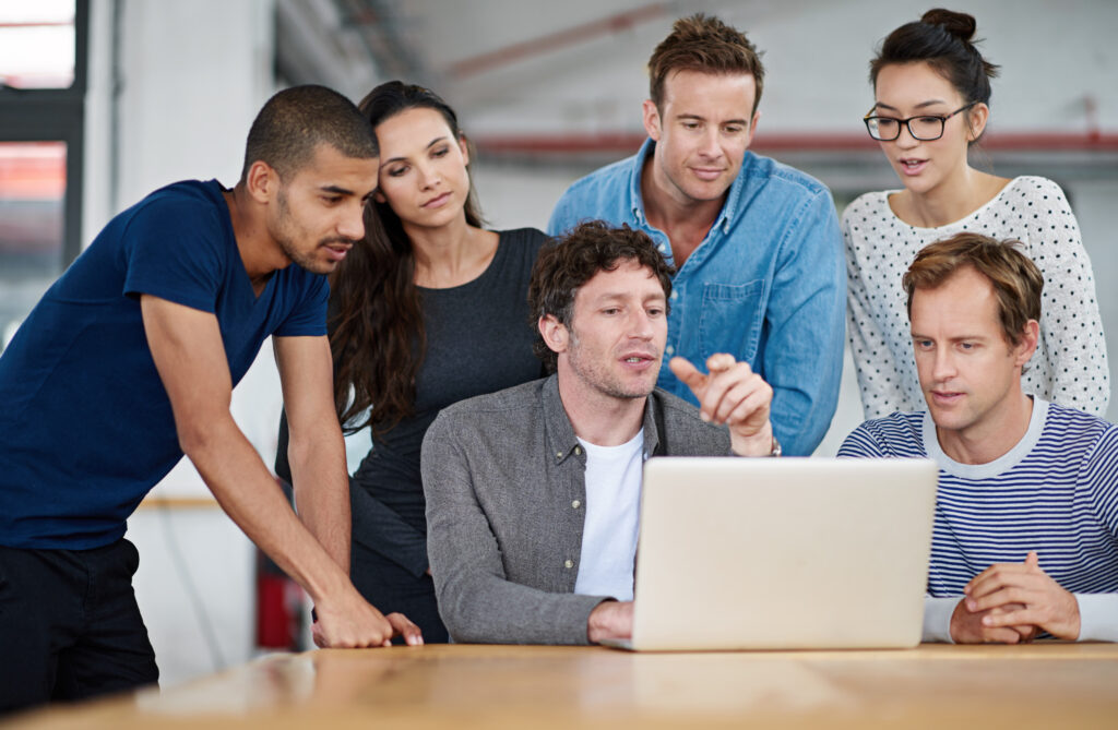 Colleagues looking at a laptop screen together